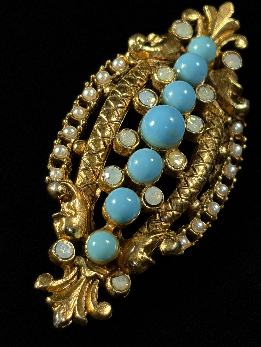 Gold-tone tennis bracelet featuring alternating marquise-cut stones in red, pink